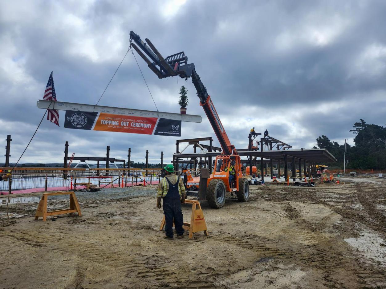 The beam is hoisted into position.