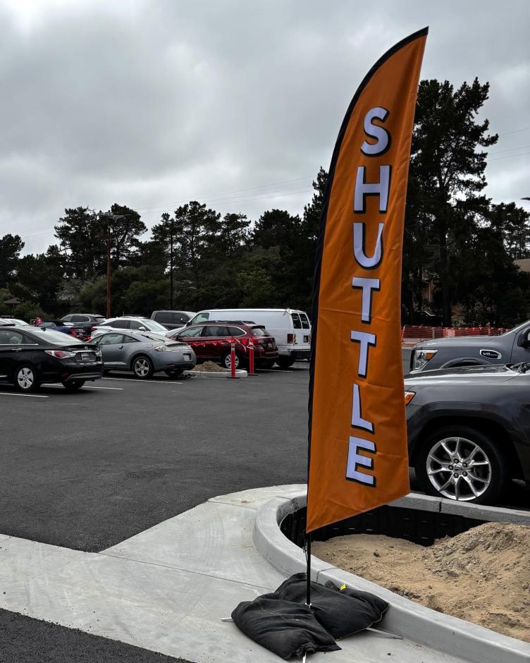 Orange flags mark the shuttle stops. For more information on shuttle service, call Republic Parking at (831) 373-8287.