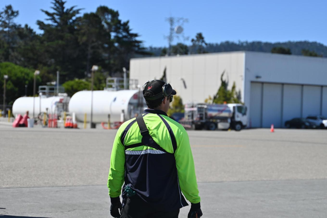 One of Monterey Jet Center's line crew members gets into position to guide an arriving general aviation aircraft.