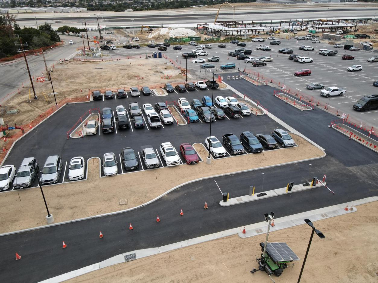 The old temporary long-term lot featured north-south parking striping while the new permanent long-term lot will feature east-west parking striping.