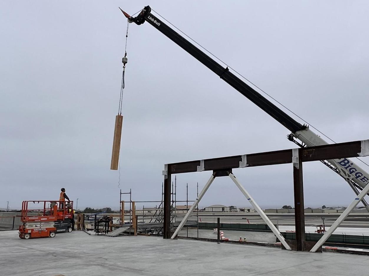 First mass timber column being lowered into place.