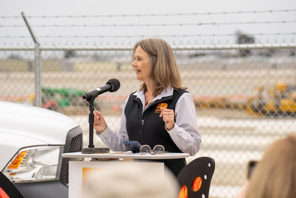 woman speaking at terminal groundbreaking event
