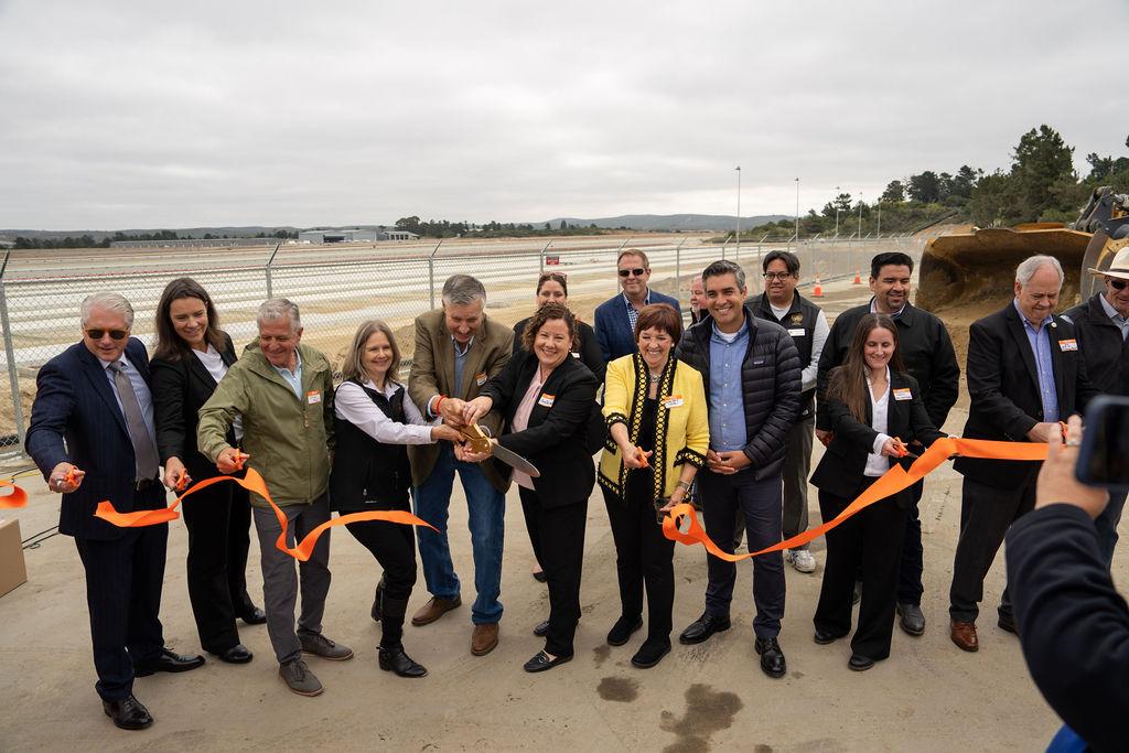 group of leaders cutting ribbon for terminal groundbreaking event