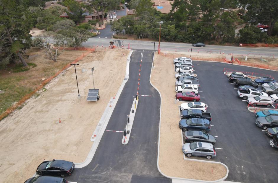 The new Entrance (temporary) and exit lane to the long term lot.  The entrances features a modern Parking Access and Revenue Control System (PARCS),  with contactless payment and remote, back-end  management.