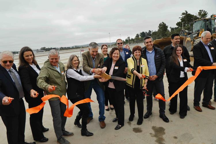 group of people cutting ribbon at groundbreaking event