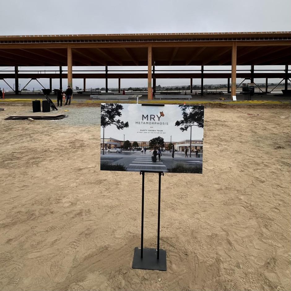 A sign featuring a rendering of the replacement terminal courtyard. A depiction of what the current construction site  will soon become.